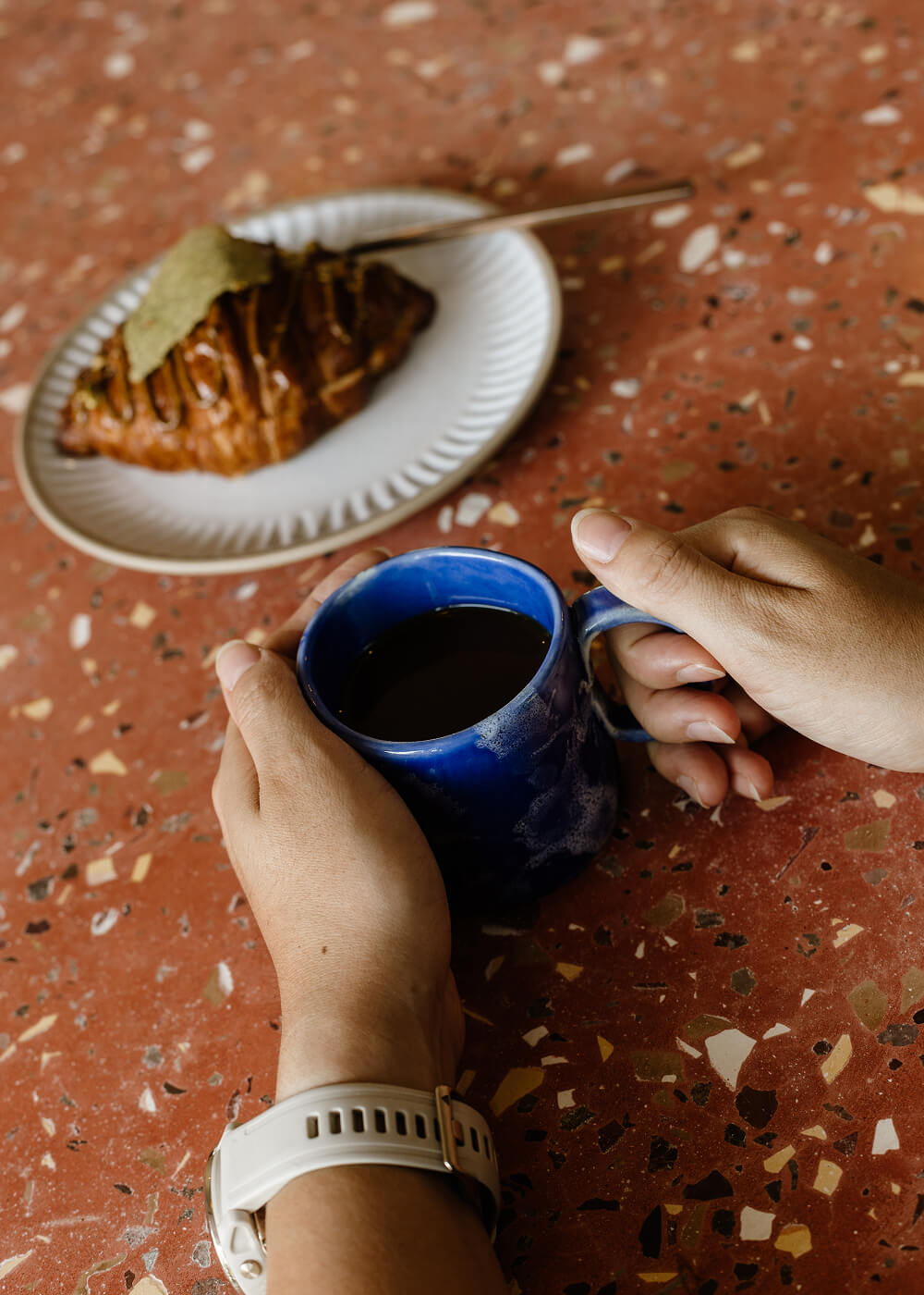 Croissant and coffee mug on a table